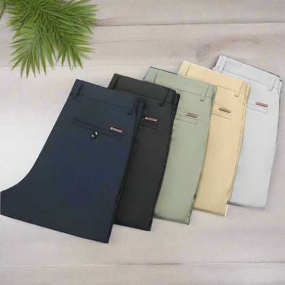 Five pairs of pants in different colors arranged on a white background