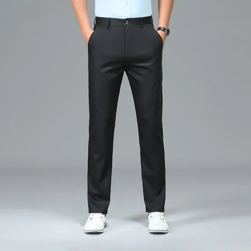 Person wearing black pants on a gray background