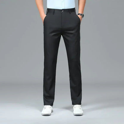 Person wearing black pants on a gray background