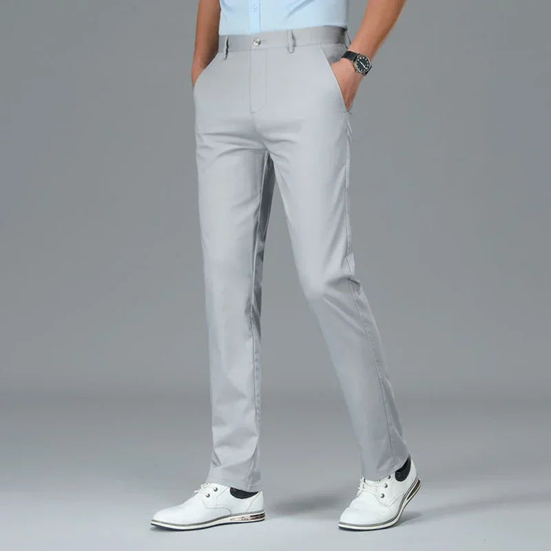 Person wearing light gray pants with a plain background