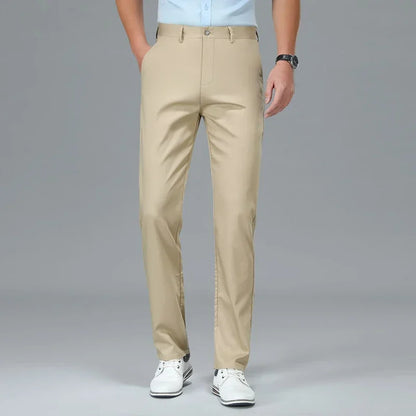 Beige pants worn by a person on a gray background