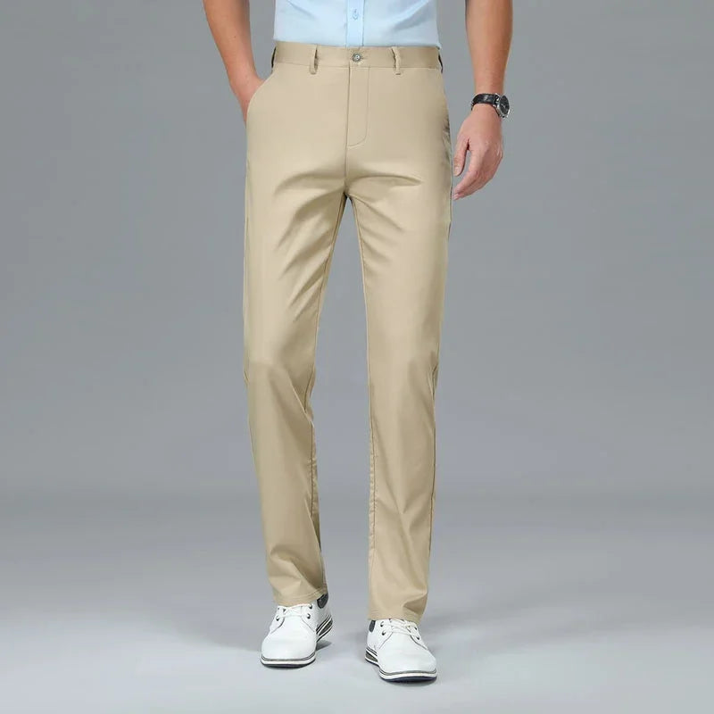 Beige pants worn by a person on a gray background
